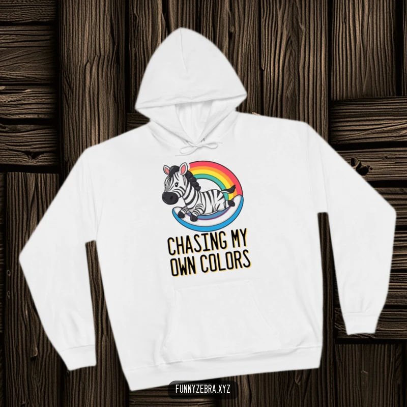 Funny Hoodie: A zebra slides down a rainbow, offering cozy humor and colorful, joyful fun.